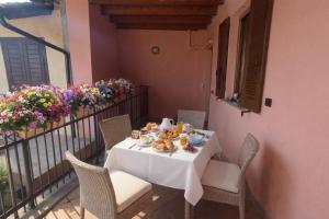 a table with a plate of food on a balcony at Sweet Simo House in Azzate +17 photos