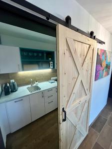 an open barn door in a kitchen with a sink at Maria Altreichenau in Neureichenau +53 photos