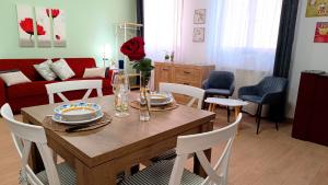 a dining room and living room with a table and chairs at Sweet Simo House in Azzate