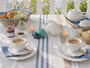 a table with two cups of coffee and pastries and candles at Loft 212 in Chitenay