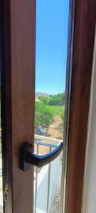 an open door with a view of a window at Alighieri Rooms in Triggiano