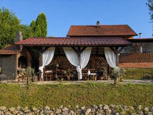 a house with a pavilion with white curtains at Kuća za odmor Kleopatra in Netretić