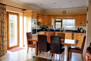 a kitchen with a wooden dining table and chairs at Laurel Lodge in Virginia
