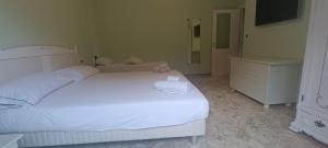 a bedroom with a large white bed and a couch at Penthouse in the historical center with sea view 5 minutes away,400mt, from main square in Amalfi
