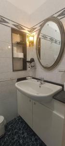 a bathroom with a white sink and a mirror at Penthouse in the historical center with sea view 5 minutes away,400mt, from main square in Amalfi +10 photos