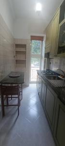 a kitchen with a table and a tableasteryasteryasteryasteryasteryasteryasteryastery at Penthouse in the historical center with sea view 5 minutes away,400mt, from main square in Amalfi