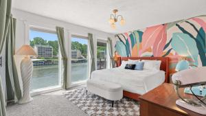 a bedroom with a bed and a large window at Daylight Cove Lakefront Chic in Lake Ozark