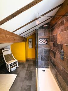 a bathroom with a shower and a bath tub at Burnlee House Apartment in Holmfirth +14 photos