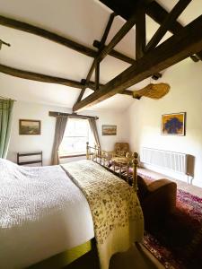 a bedroom with a large bed and a window at Burnlee House Apartment in Holmfirth