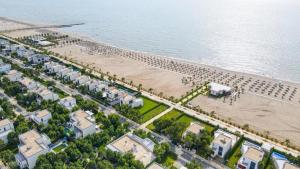 an aerial view of a beach with houses and a pier at Garden House - Hamallaj in Hamallë