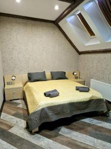a bedroom with a bed with two towels on it at White House Apart Hotel in Bălţi