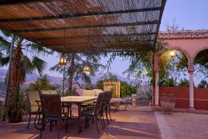 a patio with a table and chairs with a view at Villa Camilla in Comares