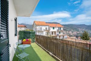 a balcony with a table and a view of a city at B&B Santa Maria in Agerola