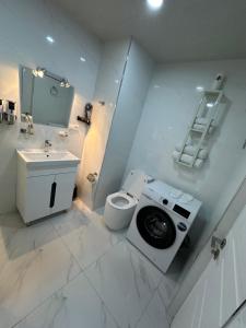 a white bathroom with a toilet and a sink at Alvina complex Vakas Tsakghadzor apartament in Tsaghkadzor +11 photos