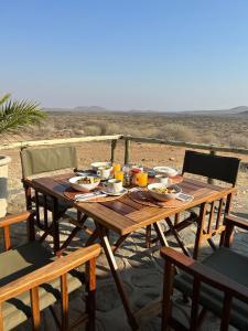 a wooden table with food on top of a beach at Düsternbrook Guest Farm in Dusternbrook
