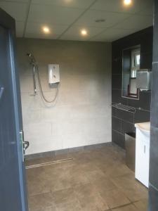 a bathroom with a shower and a sink at Rexes Hollow Camping in Yeovil Junction
