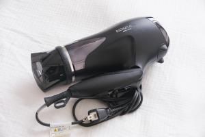 a black hair dryer sitting on a white surface at KEI HOUSE Yamato 202 in Yamato