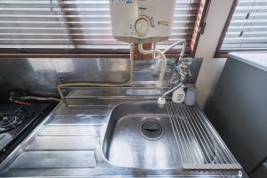 a kitchen sink with a mixer on top of it at KEI HOUSE Yamato 202 in Yamato +36 photos