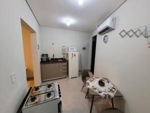 a small kitchen with a stove and a refrigerator at Casa, jd Belo Horizonte in Indaiatuba +16 photos