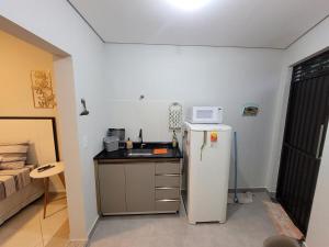 a small kitchen with a refrigerator and a microwave at Casa, jd Belo Horizonte in Indaiatuba