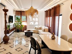 a living room with a table and a couch at Kaz An Nou in Cotonou