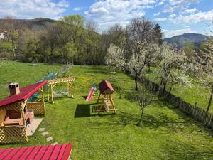 an aerial view of a playground in a field at Cozy mountain house in Trăisteni