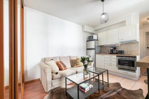a living room with a couch and a table at New flat, best location Helsinki in Helsinki