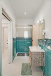 a bathroom with a sink and a shower with blue tiles at B&B Santa Maria in Agerola +48 photos