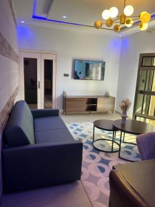 a living room with a couch and a table at Welcome Home202 Saint-Louis in Saint-Louis