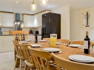 a dining room table with chairs and a kitchen at Ey Up - Uk11447 in Skipsea