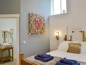 a bedroom with a bed and a sink and a mirror at Ey Up - Uk11447 in Skipsea +12 photos