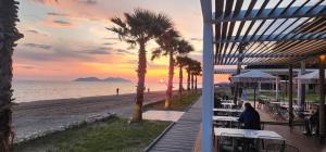 a view of a beach with tables and palm trees at Rey Garden 2 in Vlorë