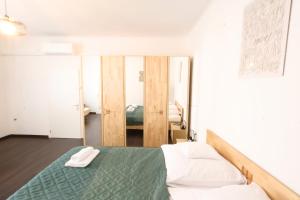 a bedroom with a bed with two towels on it at Appartementhaus Ludwig in Mörbisch am See