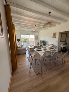 a living room with a dining room table and chairs at Appartement Bassin d' Arcachon in La Teste-de-Buch