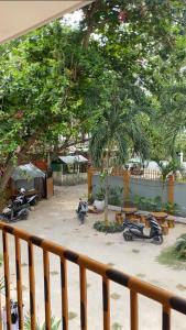 a group of motorcycles parked in a courtyard with trees at Marias's Inn in Pooc