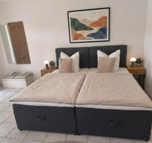 a bedroom with a large bed with pillows at Apartment Julia in Bad Orb +13 photos