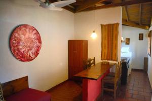 a living room with a table and a red plate on the wall at Cabañas Alfar Sol y Mar in Mar del Plata +23 photos