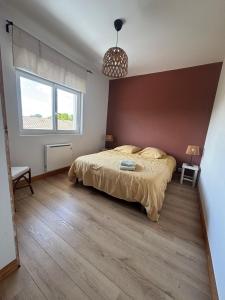 a bedroom with a large bed and a large window at Appartement Bassin d' Arcachon in La Teste-de-Buch