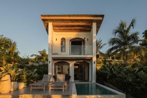 a villa with a swimming pool and a house at Native Villa with Pool at Kalumo Lodge in Oslob