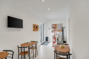 two tables and chairs in a room with a tv at B&B Santa Maria in Agerola