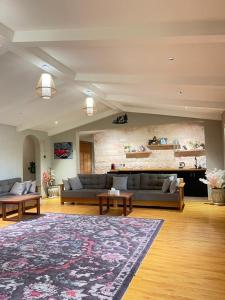 a large living room with couches and a rug at Oasis Rest ae in Madīnat an Nahḑah