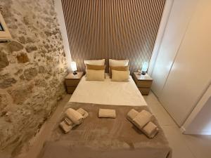 a bedroom with a bed with two pillows on it at La Ferronnerie Cassis centre in Cassis