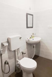 a bathroom with a toilet and a sink at Kalimpong Bungalow in Kalimpong +90 photos