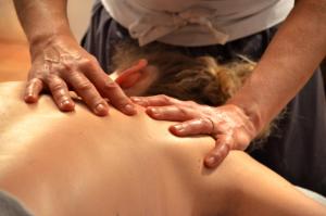 a woman receiving a back massage from a therapist at Chambre d hotes Spa montagne in Laruns +7 photos