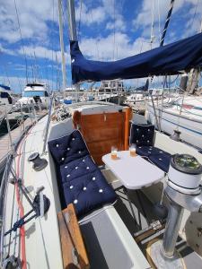 a table and chair on a boat with boats at Miramare in Playa Blanca
