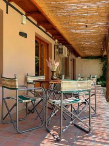 a group of chairs and a table on a patio at GuardiaPiemontese Aparts in Capilla del Monte