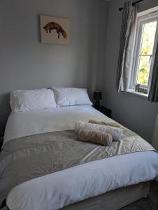 a white bed in a bedroom with a window at Fieldside View in Tydd Saint Giles