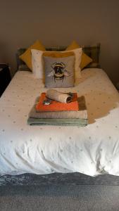 a bed with a tray with a spider on it at Fieldside View in Tydd Saint Giles