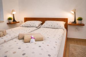 a bedroom with two beds with pillows and a pink bow at Charm Apartment-Cathedral area-Self Check-in in Sarajevo