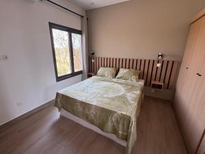 a bedroom with a bed and a window at Keur Noflaye Ngaparou in Mbour +66 photos